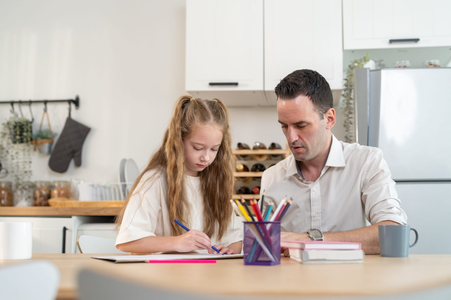 Father helping his daughter with an art project